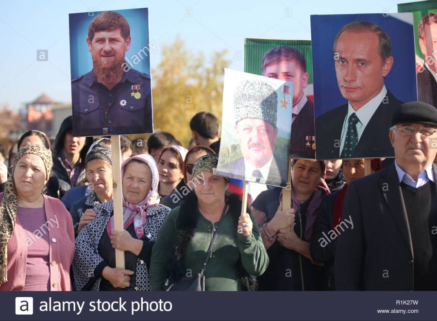 grozny-russia-04th-nov-2018-grozny-russia-november-4-2018-people-with-placards-showing-portraits-of-ramzan-kadyrov-akhmad-kadyrov-and-vladimir-putin-during-a-celebration-marking-national-unity-day-in-grozny.jpg