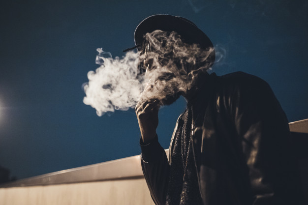 portrait-of-young-black-man-standing-outdoor-smoking-cigarette_108985-314.jpg